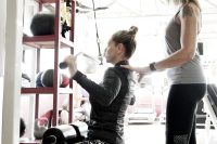 Female, personal training client, with trainer